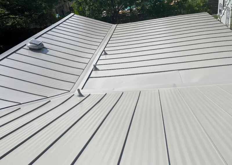Solar attic fan installed on a metal roof for Roof Ventilation in Greendale